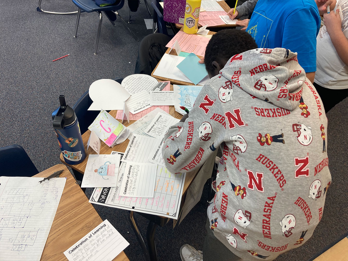 A student offers peer-to-peer feedback during an Exhibition of Learning.