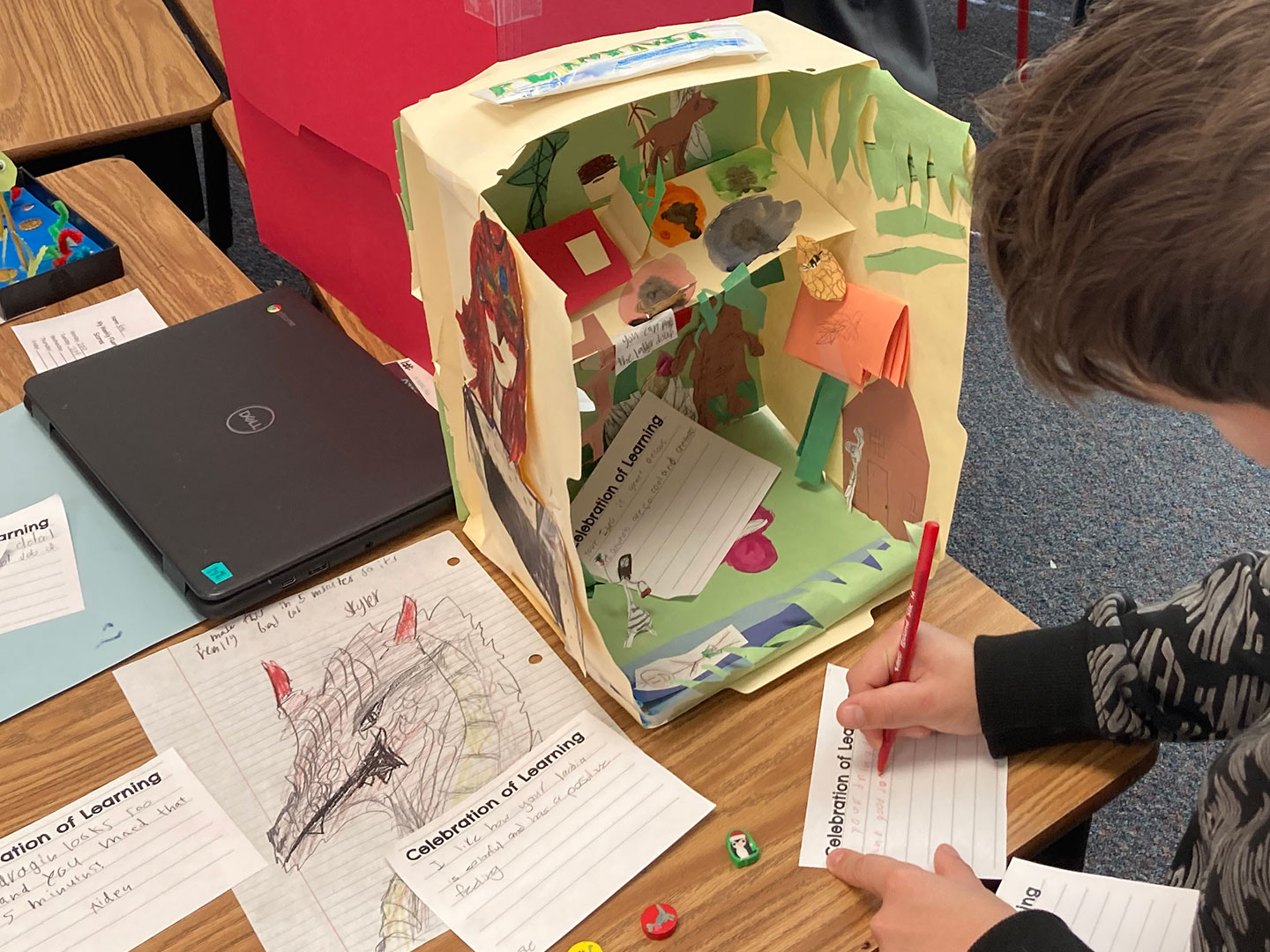 A student offers peer-to-peer feedback during an Exhibition of Learning.